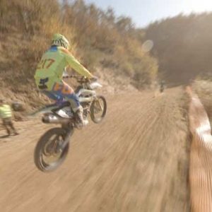 Aerial shot of motocross racers on dirt trail. FPV drone shoot